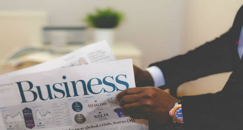 Man reading Business newspaper