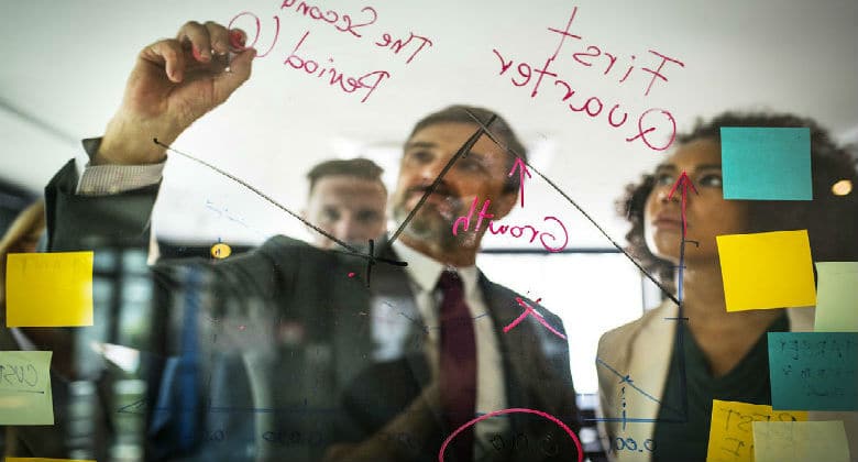 Man drawing on a board in a meeting