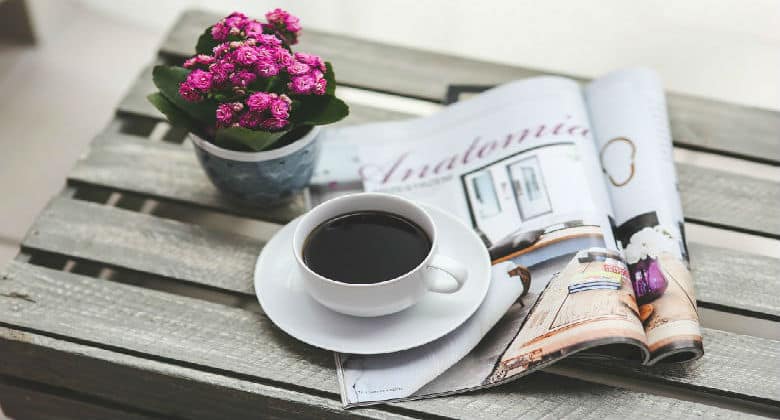 Coffee cup on a magazine
