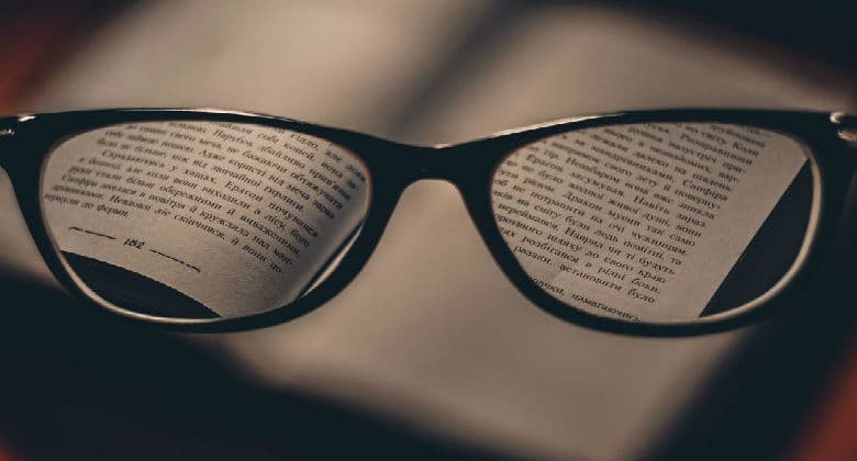 Reading a book through a reading glasses