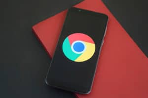 Google Chrome icon on smart phone on red and black surface