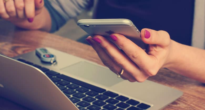 Lady on phone infront of laptop